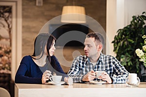 People, communication and dating concept - happy couple drinking tea at cafe