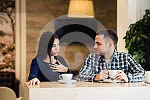People, communication and dating concept - happy couple drinking tea at cafe