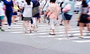 People commuting in rush hour at zebra crossing