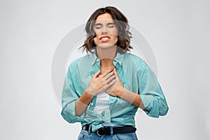 Young woman having heartache or heartburn photo