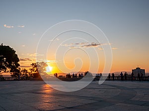 People contemplate the sunrise on the summit of Mount-Royal, Montreal, Quebec, Canada