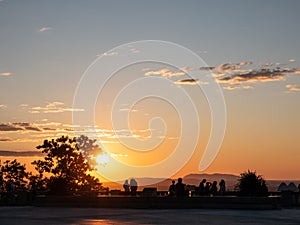 People contemplate the sunrise on the summit of Mount-Royal, Montreal, Quebec, Canada