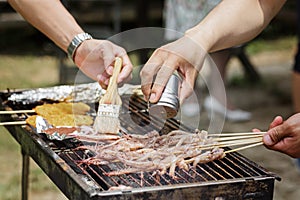 People cooking barbecue outdoor. Summer party with grilled food