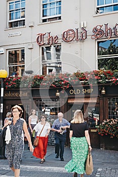 People crossing the road in front of The Old Ship pub in Richmond, London, UK.