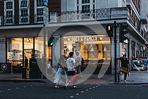 People crossing the road in front of Pret A Manger in London, UK.