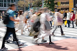People Crossing a Street in a City Centre on a Sunny Day