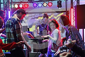 People dancing while dj performing live