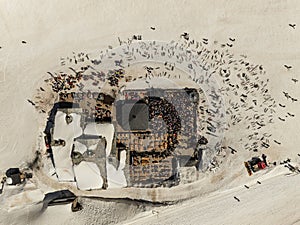 People dancing in a mountain bar in the ski resort of Les 2 Alpes, France. Aerial drone view of people enjoying apres-ski. Apres