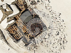 People dancing in a mountain bar in the ski resort of Les 2 Alpes, France. Aerial drone view of people enjoying apres-ski. Apres