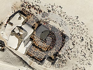 People dancing in a mountain bar in the ski resort of Les 2 Alpes, France. Aerial drone view of people enjoying apres-ski. Apres