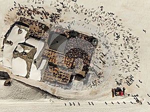 People dancing in a mountain bar in the ski resort of Les 2 Alpes, France. Aerial drone view of people enjoying apres-ski. Apres