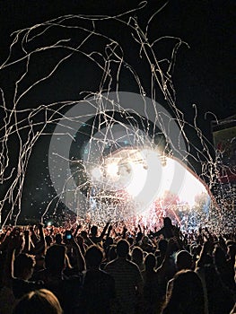 People dancing on an open air concert at night photo