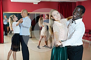 People dancing slow ballroom dances in pairs