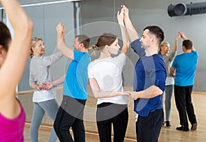 People dancing social dances in pair