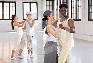 People dancing twist in pairs in studio