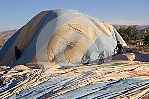 People are deflating the hot air balloon after the flyght over Cappadocia, Turkey