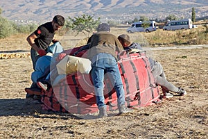 People are deflating the hot air balloon after the flyght over Cappadocia, Turkey