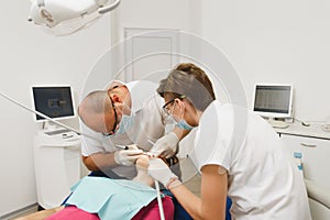 People in the dental clinic are treating their teeth