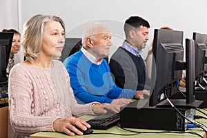 People of different ages learning to use computers