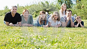 People of different ages taking photos on the lawn