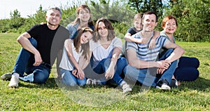 People of different ages taking photos on the lawn