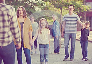 People of different ages walk in park