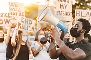 People from different culture and races protest on the street for equal rights - Demonstrators wearing face masks during black