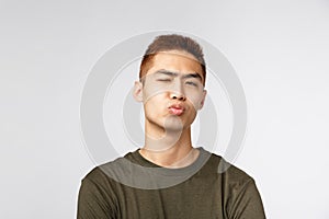 People, different expressions and lifestyle concept. Close-up portrait of funny silly, handsome young guy pouting