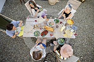 People dining outdoors, view on table from above