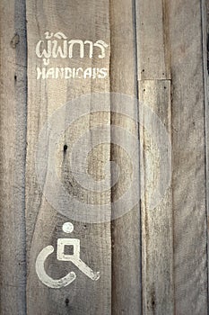 People with Disabilities toilet vintage label on a wooden backgr