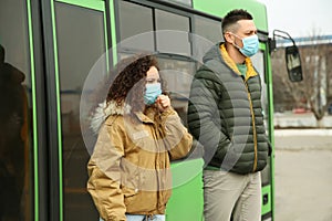 People with disposable masks near bus. Virus protection