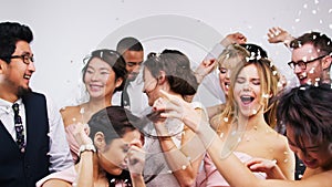 People, diversity and dancing in wedding reception celebration, marriage success or event with falling confetti on