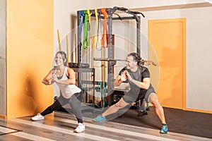 People doing adductor stretch exercise in gym