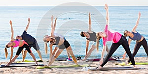 People doing exercises on beach