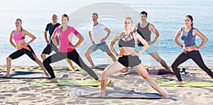 People doing exercises on beach