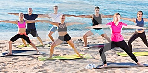 People doing exercises on beach