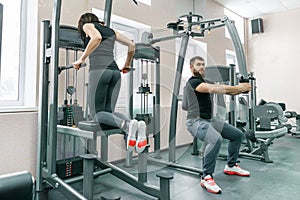 People doing exercises on simulators in the gym. Fitness, sport, training, people, healthy lifestyle concept