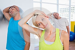 People doing neck exercise in fitness club