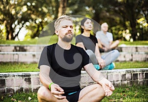 People doing yoga at the park