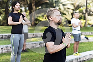 People doing yoga at the park