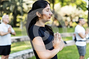 People doing yoga at the park