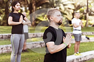 People doing yoga at the park