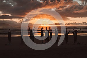 People doing yoga sunset