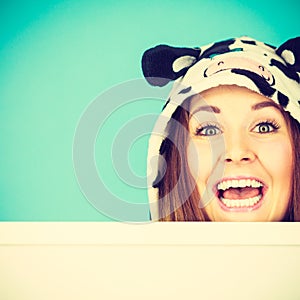 Happy crazy woman in cow costume holding board