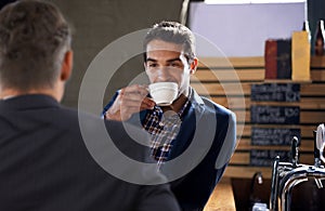 People, drink and coffee in pub for business meeting, appointment or consultation in Dublin. Businessmen, smile and hot