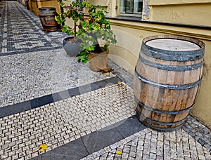 people drink from old barrique barrels in front of the restaurant.