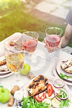 People drink rose and white wine. Dinner with grilled fish, vegetables and salads. Dinner in the backyard. Vertical shot