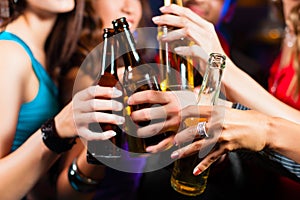 People drinking beer in bar or club
