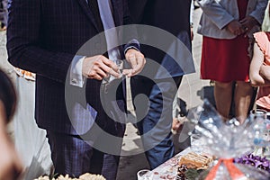 People drinking vodka during celebration hands closeup, wedding guests drinking vodka and toasting newlywed couple concept