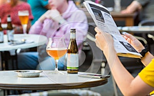 People drinks beer in street cafe, Europe